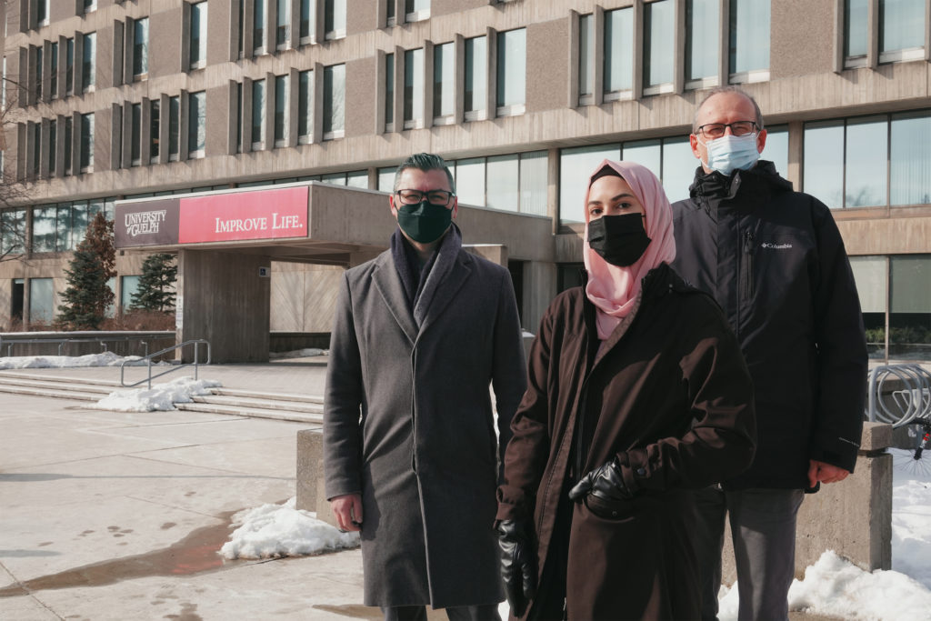 People wearing masks in front of school