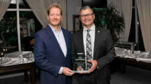 Stuart Aker from Cogeco hands Nick Mocan the Business Person of the Year Award